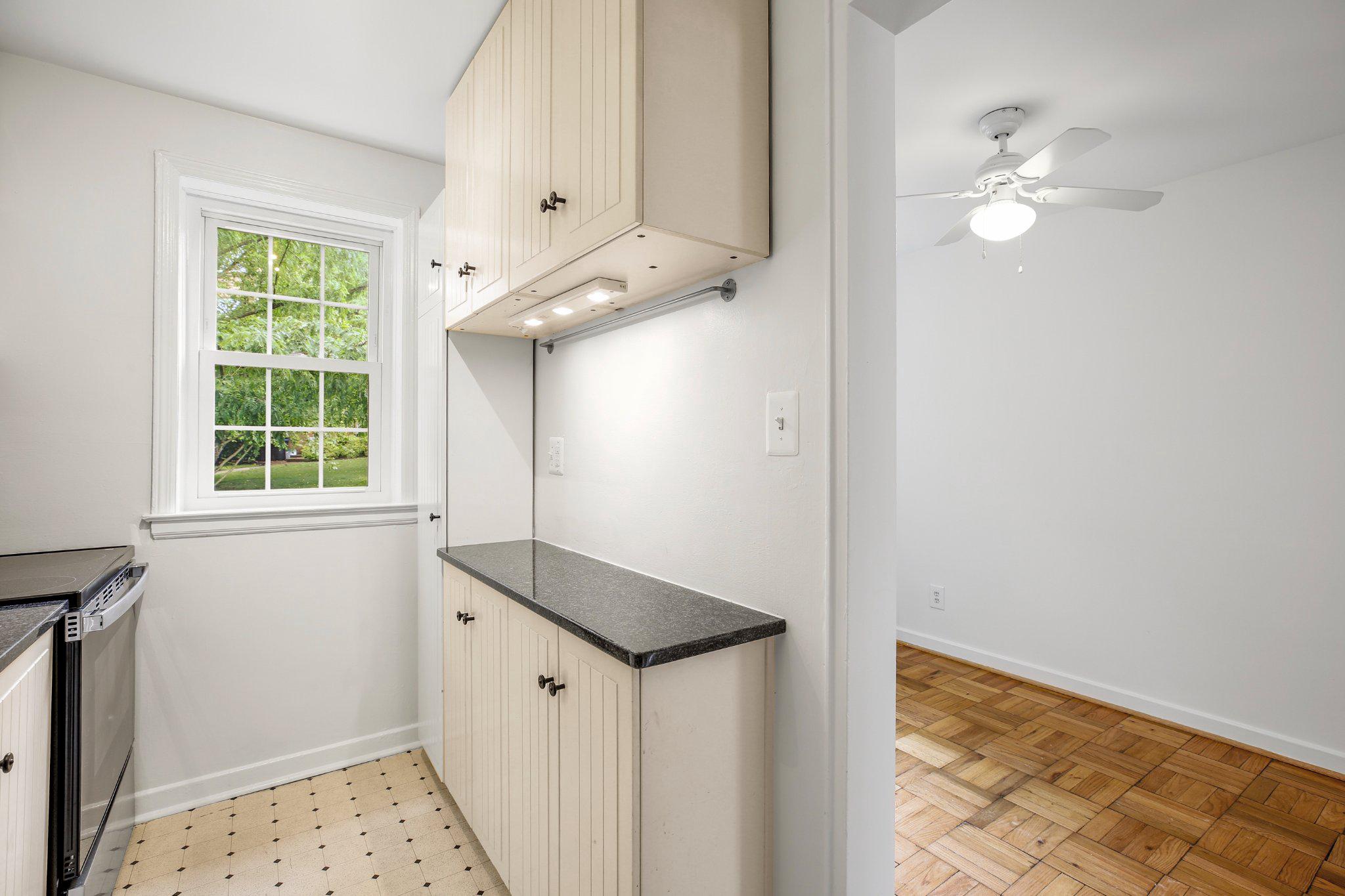 2202 Colston Drive, Unit 102 Silver Spring, MD 20910 - Photo 11 of 38 a view of a hallway to a window and chandelier