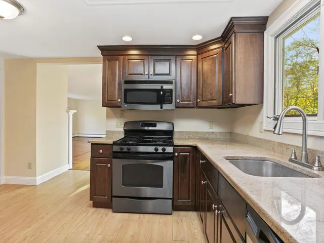 a kitchen with a sink stove and microwave