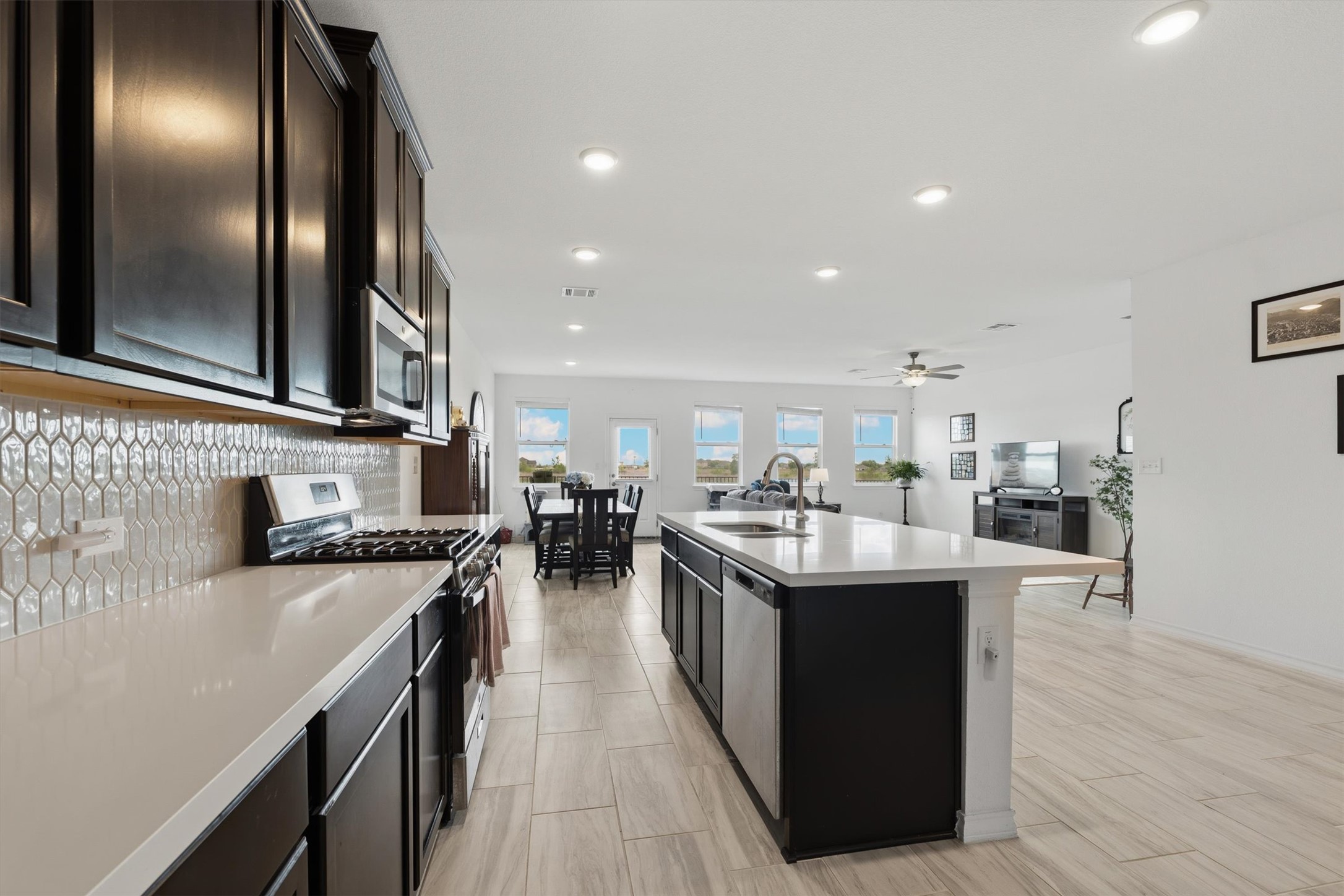 1000 Moose Road Hutto, TX 78634 - Photo 29 of 29 Kitchen featuring stainless steel appliances, an island with sink, open floor plan, recessed lighting, and backsplash