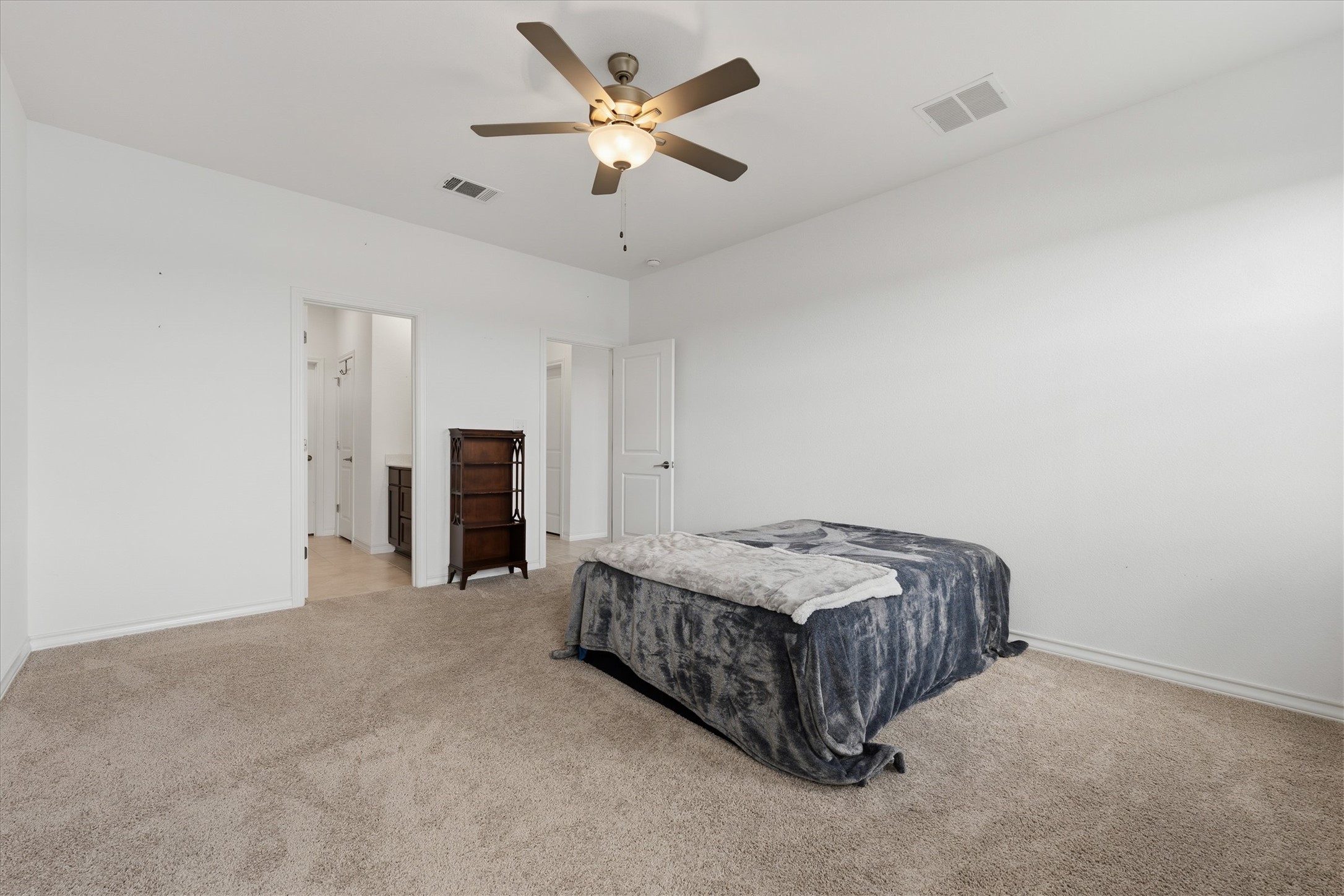 1000 Moose Road Hutto, TX 78634 - Photo 21 of 29 Carpeted bedroom with a ceiling fan and ensuite bath