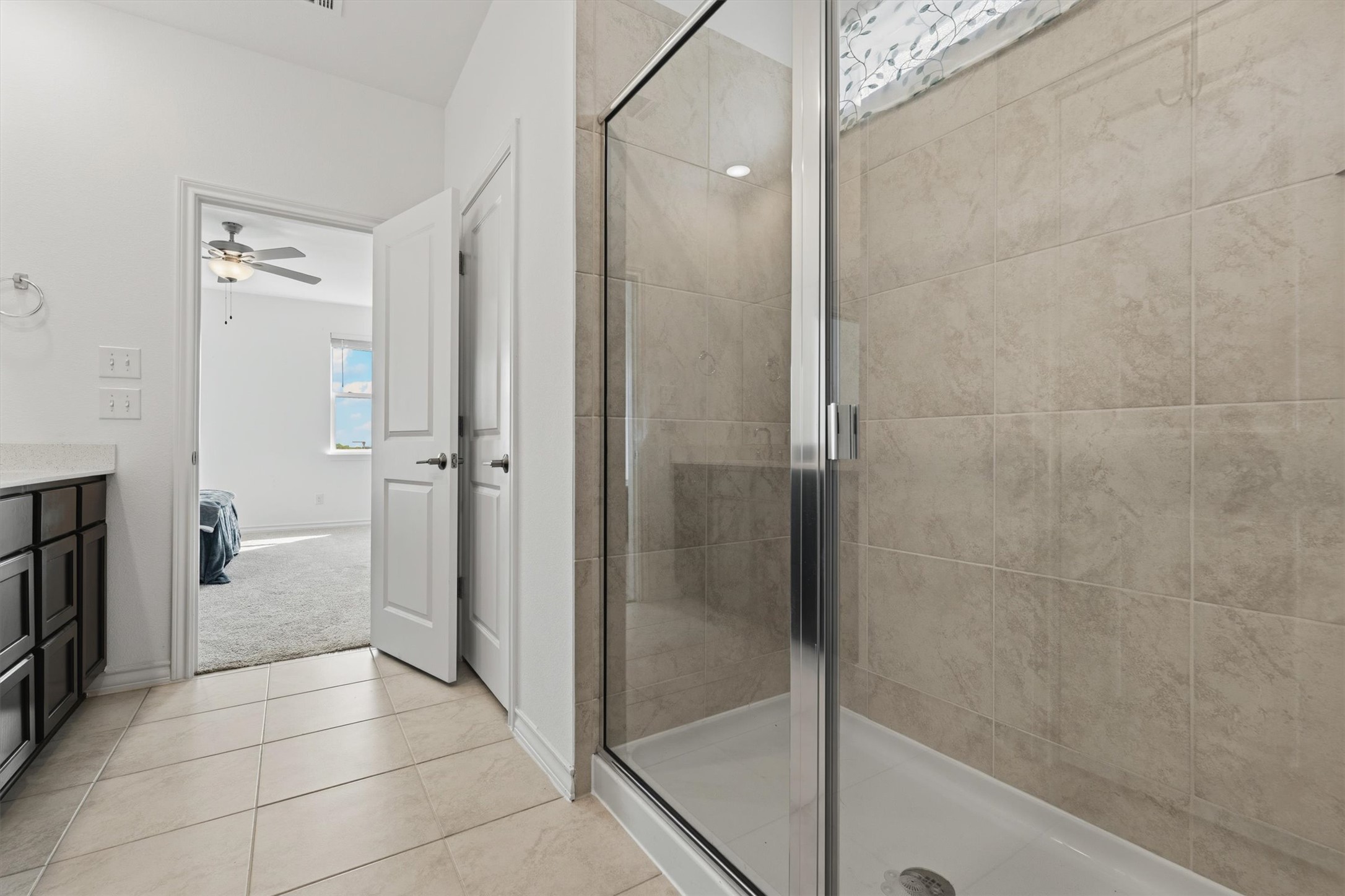 1000 Moose Road Hutto, TX 78634 - Photo 23 of 29 Bathroom with ensuite bath, a shower stall, vanity, and light tile patterned floors