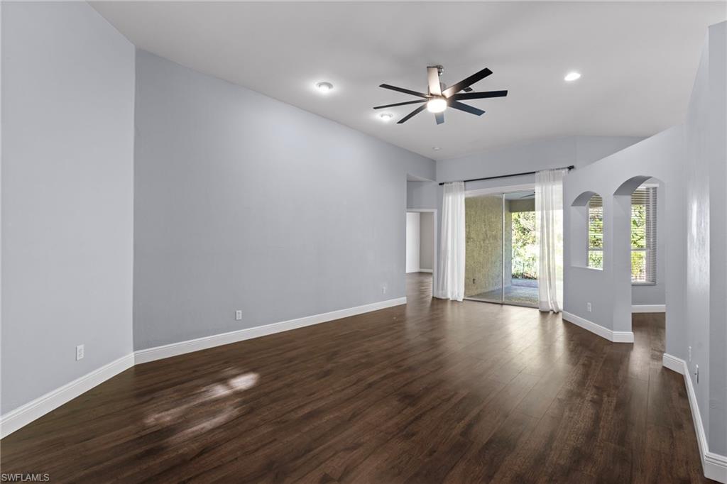 22932 Forest Ridge Drive Estero, FL 33928 - Photo 14 of 41 a view of an empty room with wooden floor and a window