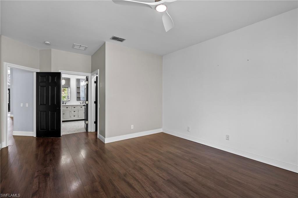 22932 Forest Ridge Drive Estero, FL 33928 - Photo 17 of 41 a view of an empty room with wooden floor