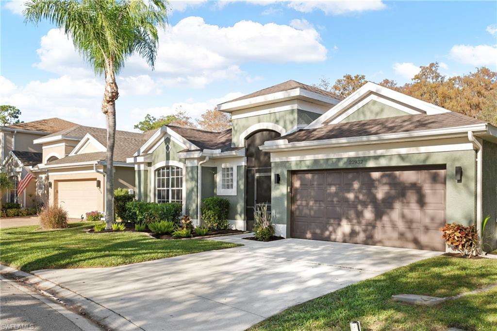 22932 Forest Ridge Drive Estero, FL 33928 - Photo 2 of 41 a front view of a house with garden