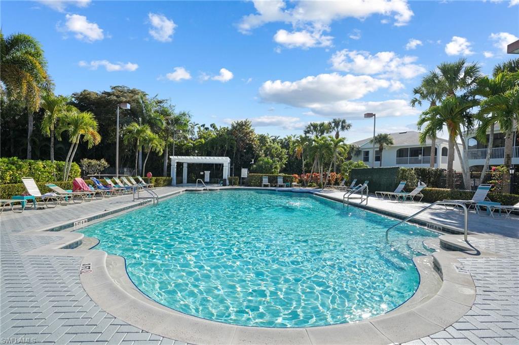 22932 Forest Ridge Drive Estero, FL 33928 - Photo 35 of 41 a view of a swimming pool with a patio and plants