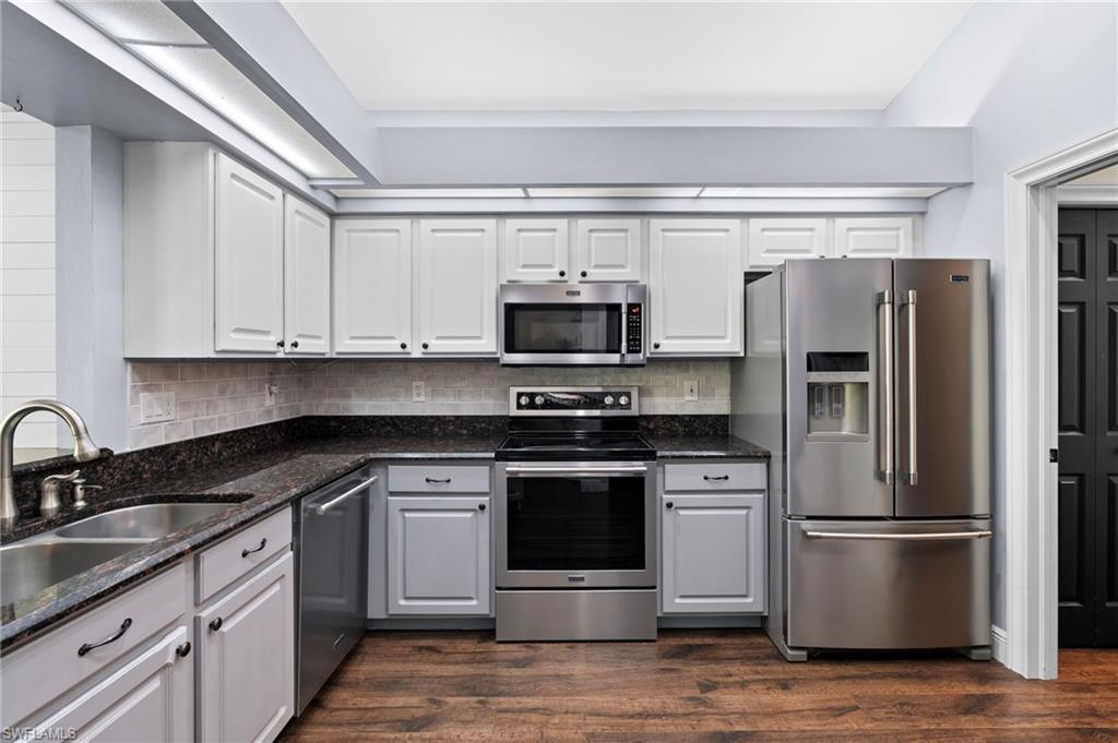 22932 Forest Ridge Drive Estero, FL 33928 - Photo 9 of 41 a kitchen with a sink stainless steel appliances and cabinets