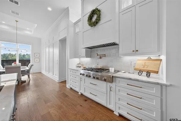 a kitchen with granite countertop white cabinets and white appliances