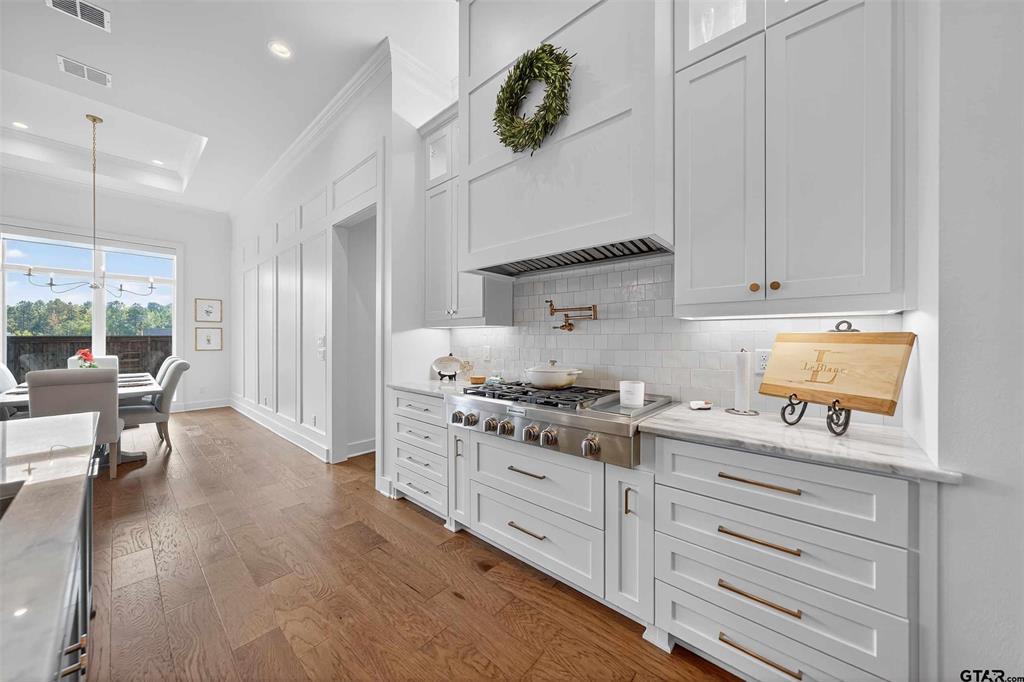 1572 Maple Lane Tyler, TX 75703 - Photo 13 of 40 a kitchen with granite countertop white cabinets and white appliances
