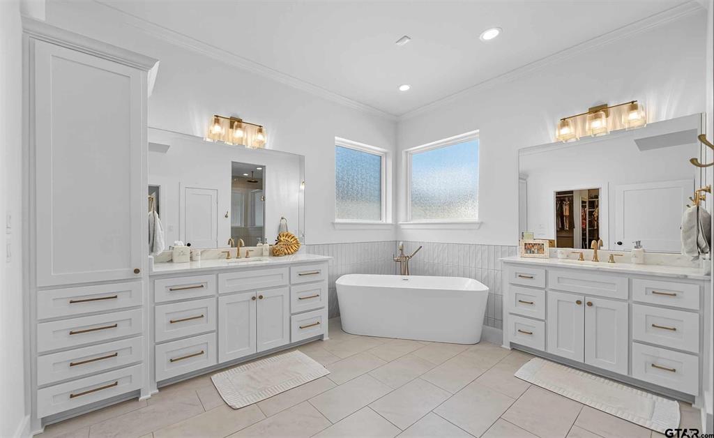 1572 Maple Lane Tyler, TX 75703 - Photo 21 of 40 a spacious bathroom with a double vanity sink mirror and bathtub