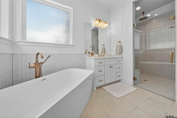 a bathroom with a double vanity sink mirror and shower
