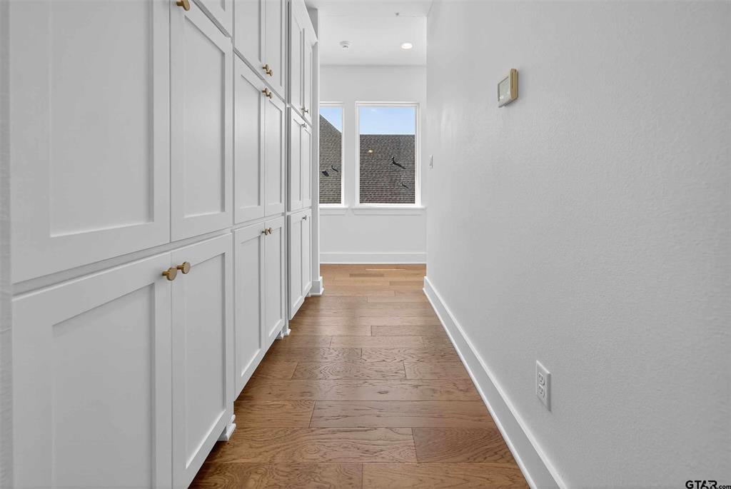 1572 Maple Lane Tyler, TX 75703 - Photo 23 of 40 a view of a hallway with wooden floor and staircase