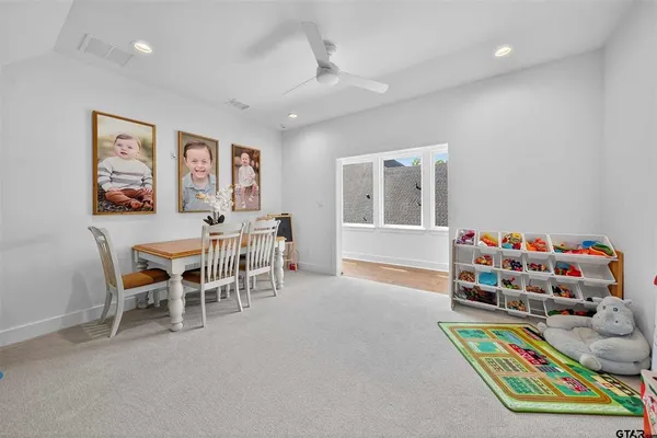 a living room with furniture and a dining table with chair
