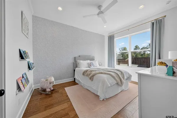 a bedroom with a bed and wooden floor