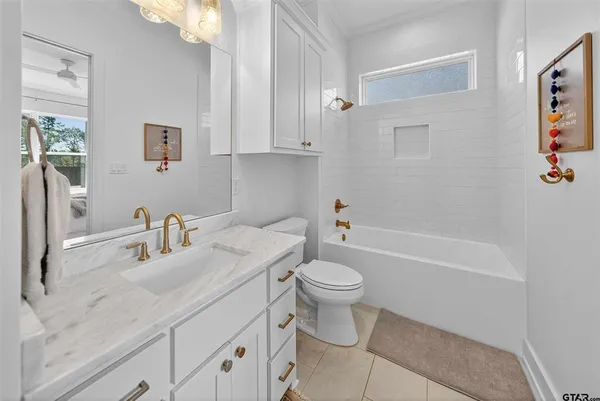 a bathroom with a sink a toilet and bathtub