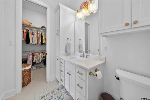 a bathroom with a sink a mirror and a toilet