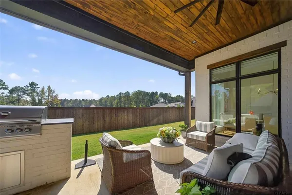 a view of a balcony with chairs and a potted plant