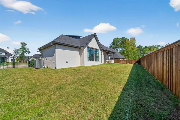 a view of a house with backyard and a tree