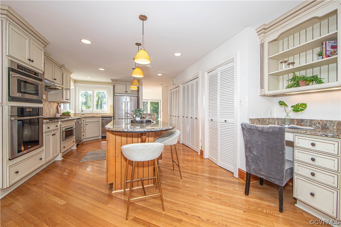 4206 Winterberry Court Midlothian, VA 23112 - Photo 12 of 50 a kitchen with stainless steel appliances a dining table chairs stove and cabinets