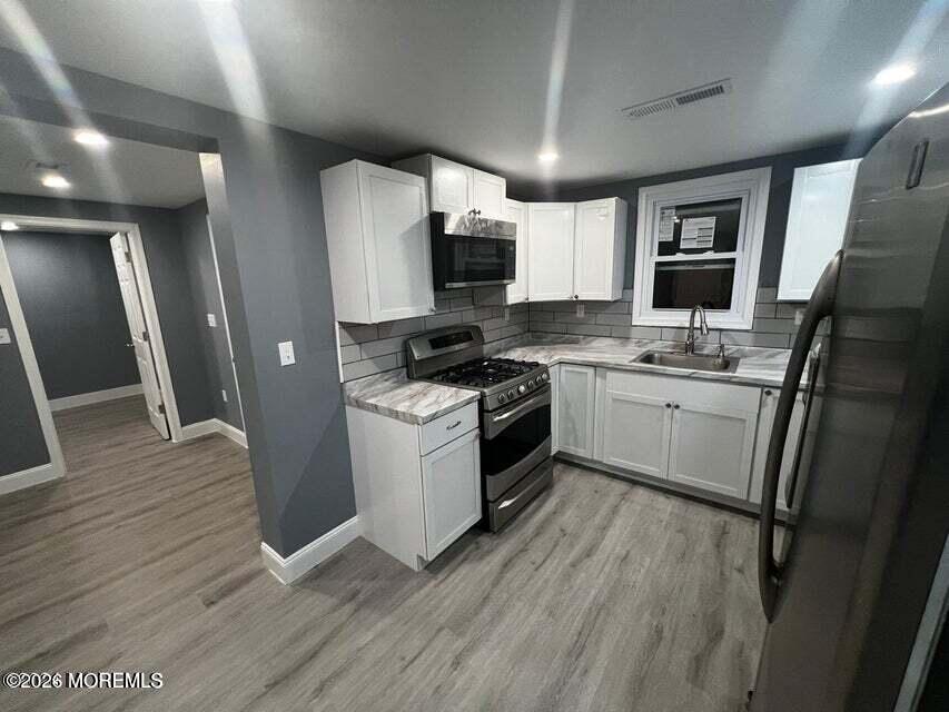 6611 Magnolia Drive Millville, NJ 08332 - Photo 4 of 14 a kitchen with a sink appliances and cabinets