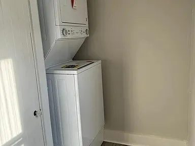 a kitchen with a sink and a stove top oven with wooden floor