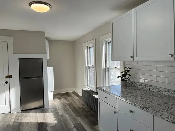 a view of a room with wooden floor windows and wooden floor