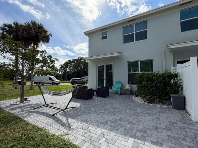 a swimming pool with outdoor seating and yard