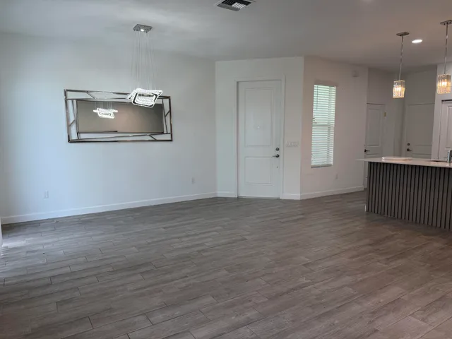 a view of a room with wooden floor and cabinet