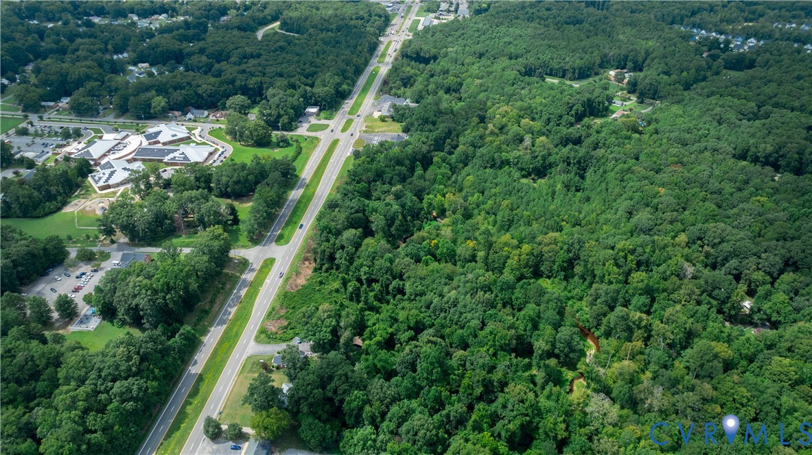 2106 East Hundred Road Chester, VA 23836 - Photo 6 of 14 an aerial view of residential house with outdoor space and trees all around