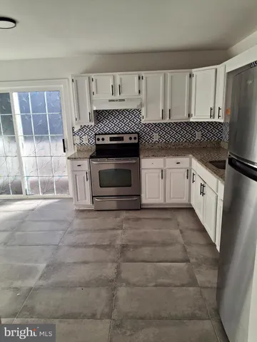 a kitchen with granite countertop a stove top oven a sink and a granite counter tops