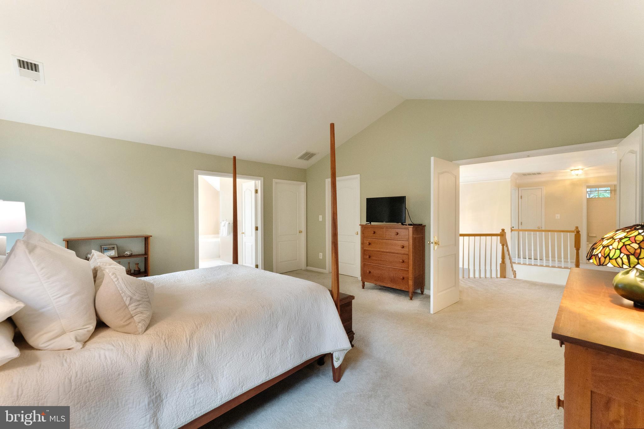 1309 Murray Downs Way Reston, VA 20194 - Photo 23 of 63 a bedroom with a large bed and a tv