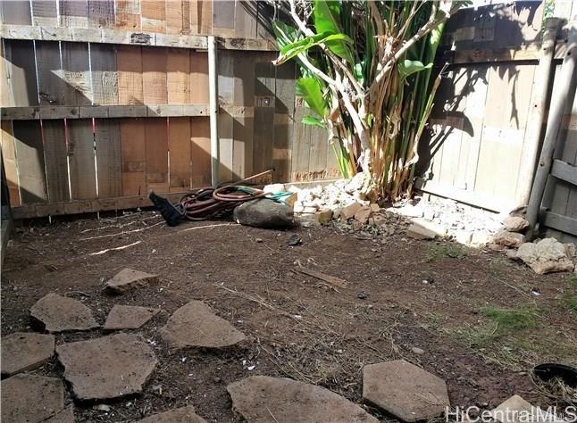 87-149 Helelua Street, Unit 3 Waianae, HI 96792 - Photo 4 of 5 a backyard of a house with outdoor seating