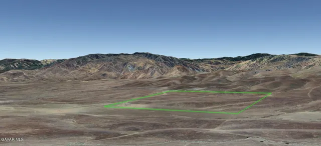 a view of a yard with a mountain