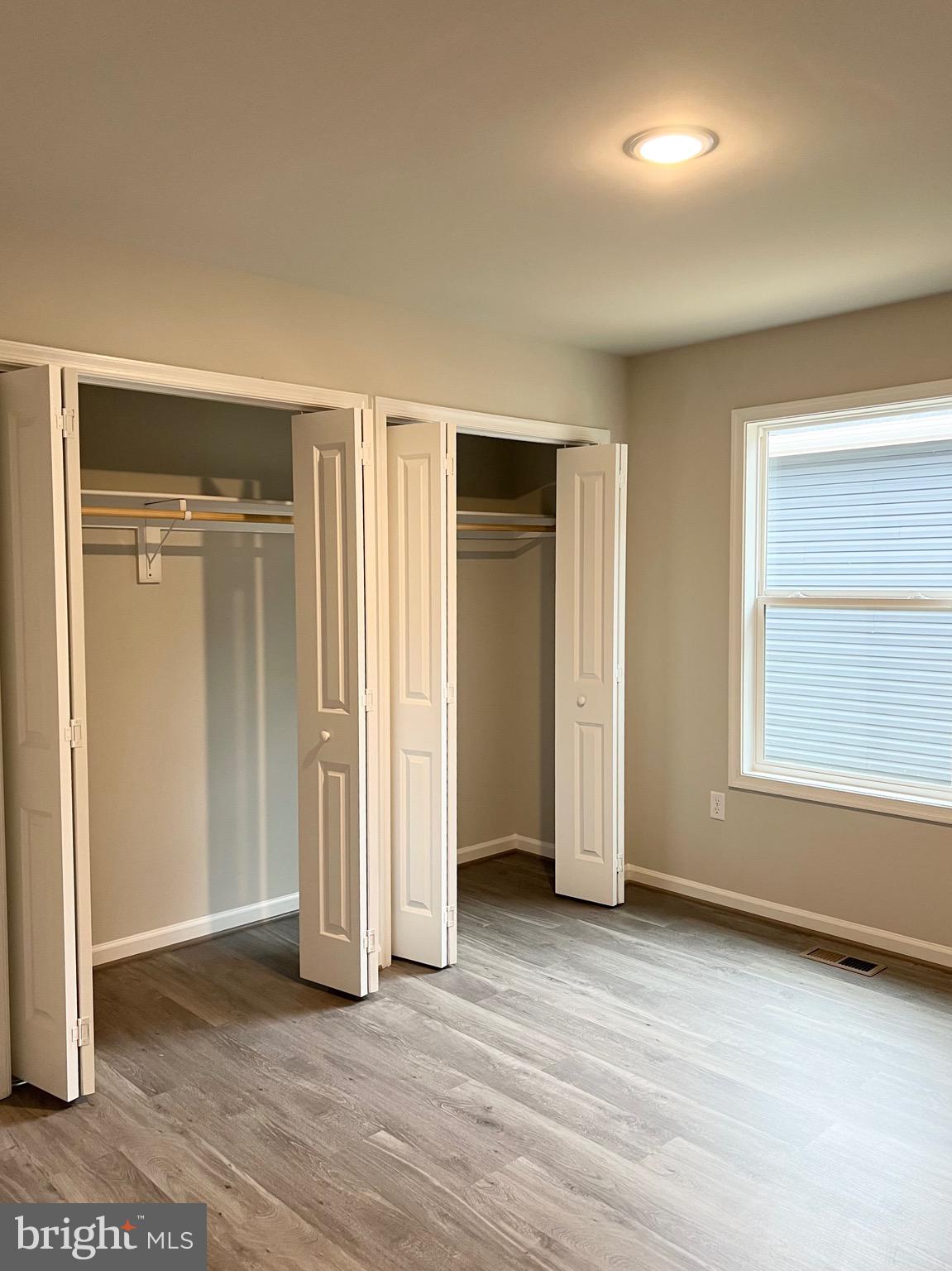 255 9th Street Colonial Beach, VA 22443 - Photo 11 of 18 an empty room with wooden floor and windows