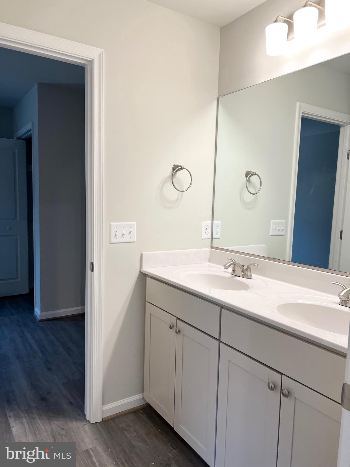 255 9th Street Colonial Beach, VA 22443 - Photo 13 of 18 a bathroom with a double vanity sink and mirror