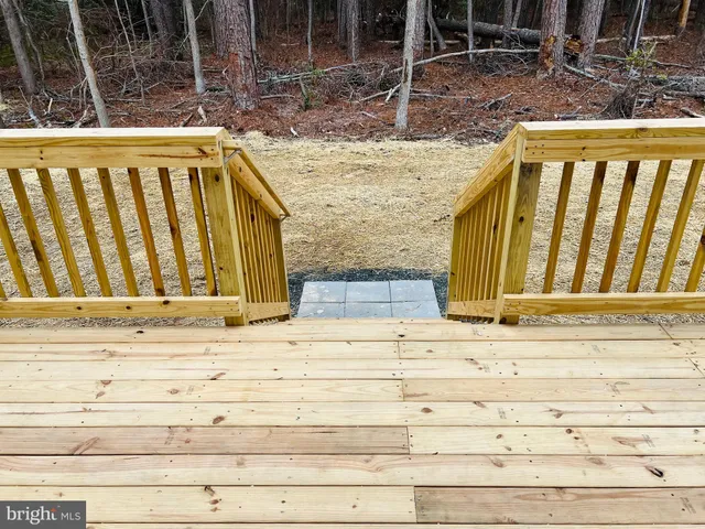a view of wooden floor with a bench