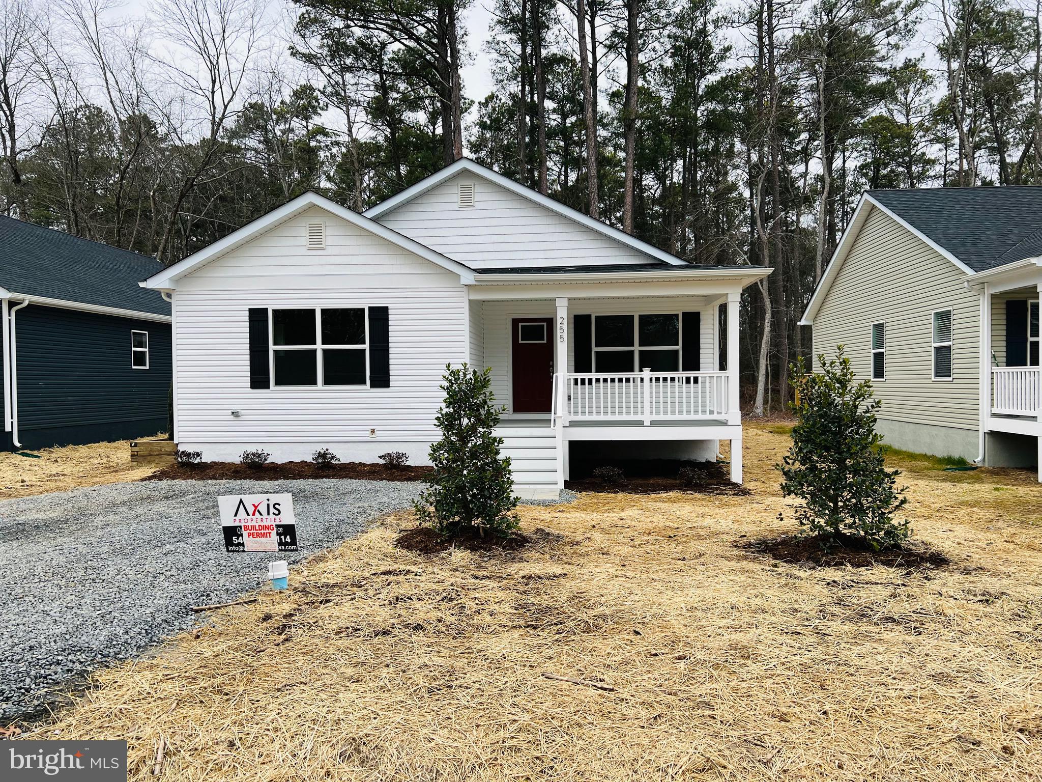 255 9th Street Colonial Beach, VA 22443 - Photo 3 of 18 a front view of a house with a yard and garage