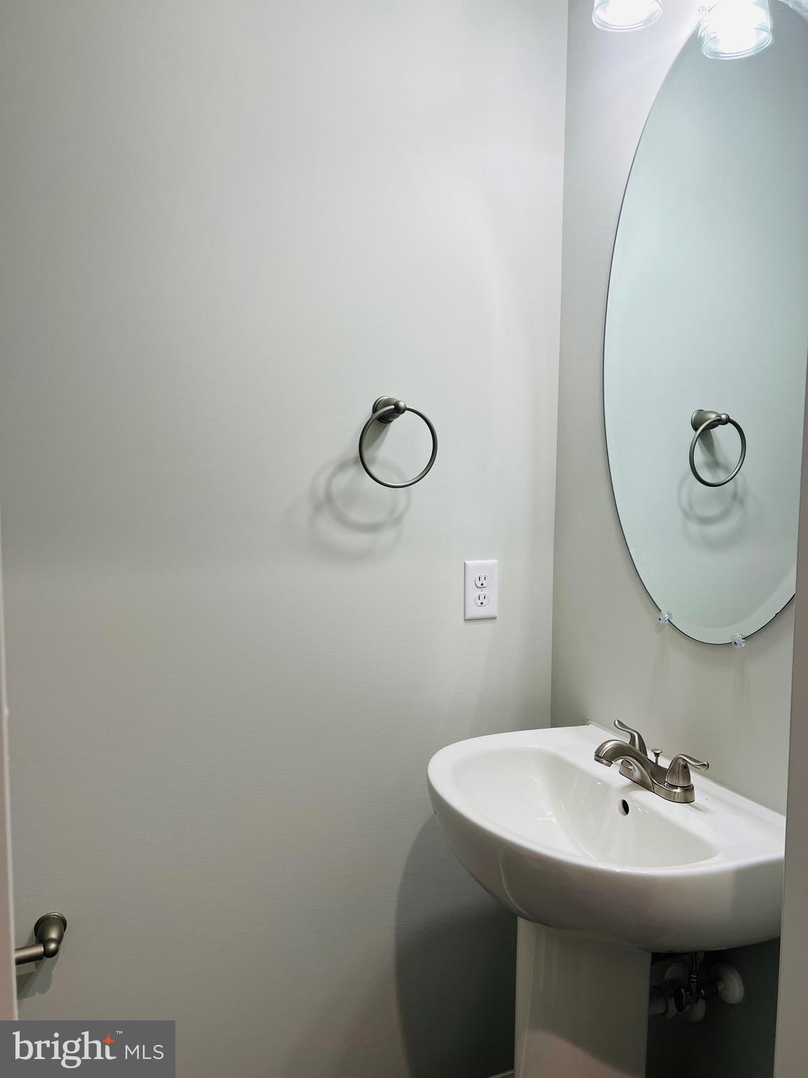 255 9th Street Colonial Beach, VA 22443 - Photo 9 of 18 a bathroom with a sink and mirror