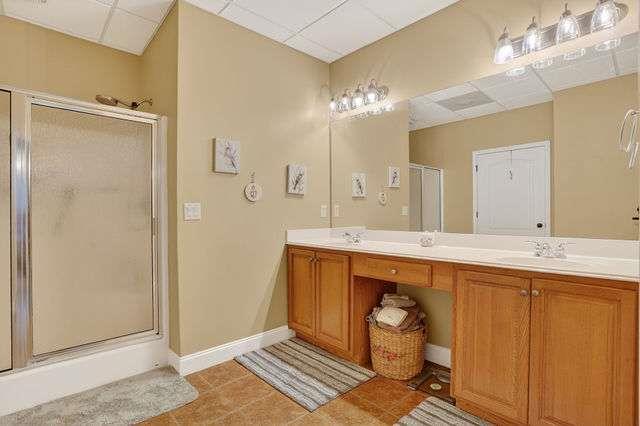 8179 Pineview Court Villa Rica, GA 30180 - Photo 23 of 41 a spacious bathroom with a sink a mirror and a shower