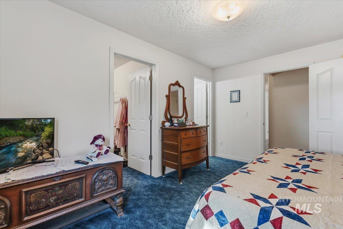 2331 Gulley Road Homedale, ID 83628 - Photo 19 of 46 Carpeted interior space featuring white walls and a white ceiling with a flush-mount light fixture