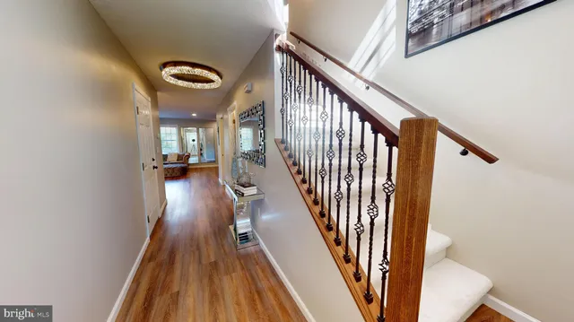 a view of entryway and hall with wooden floor