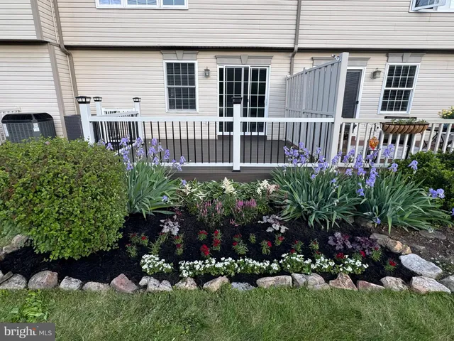 a view of a house with a flower garden