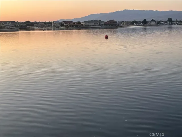 a view of a lake with houses in background