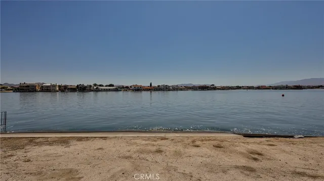 a view of a lake with houses in the back