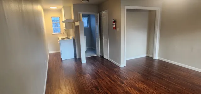 a view of a hallway with wooden floor