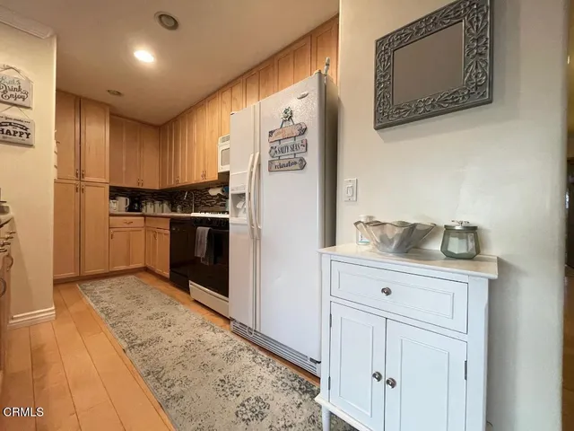 a kitchen with stainless steel appliances granite countertop a refrigerator and a stove