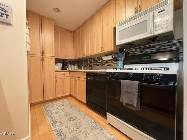 a kitchen with a stove and a microwave