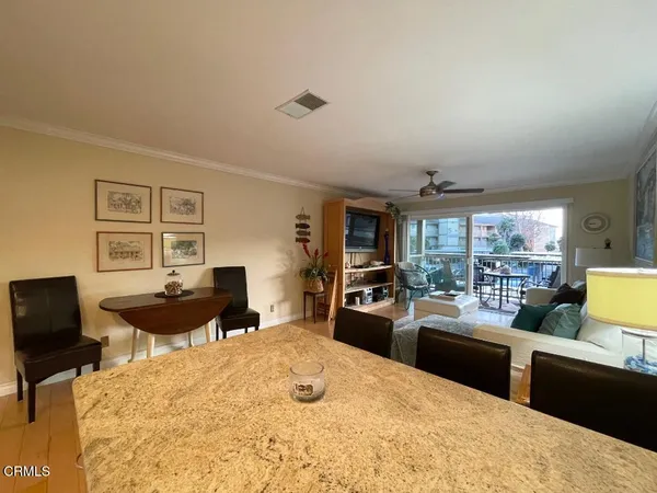 a kitchen with a table chairs stove and refrigerator