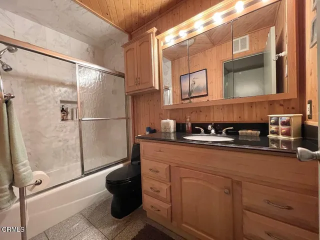 a bathroom with a sink a mirror and a shower