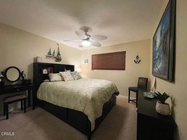 a bedroom with a bed and dresser