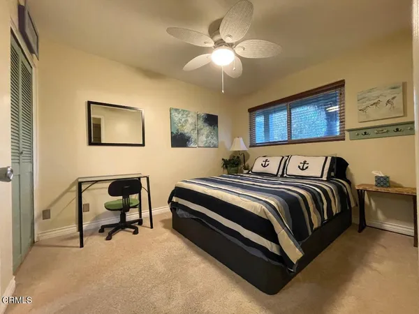 a bed room with a bed and a chair